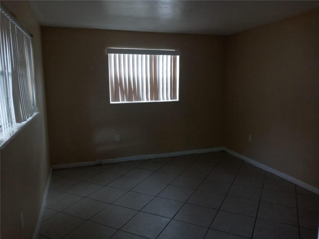Undisclosed Address Sunrise, FL 33313 - Photo 2 of 15 an empty room with windows