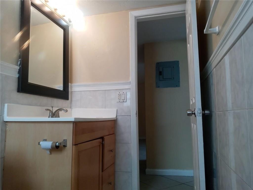 Undisclosed Address Sunrise, FL 33313 - Photo 3 of 15 a bathroom with a sink and mirror