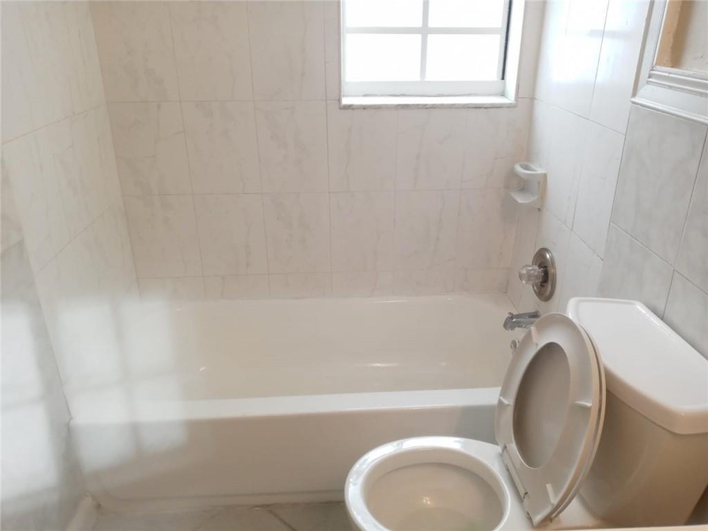 Undisclosed Address Sunrise, FL 33313 - Photo 4 of 15 a bathroom with a sink a toilet and bathtub