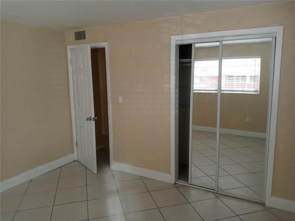 Undisclosed Address Sunrise, FL 33313 - Photo 5 of 15 an empty room with window and mirror