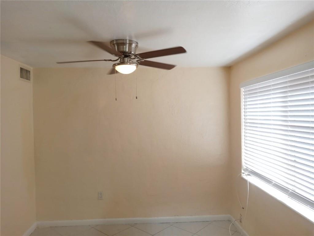 Undisclosed Address Sunrise, FL 33313 - Photo 6 of 15 an empty room with a window and a fan