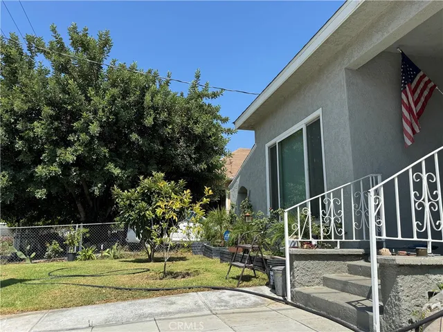 a view of a house with backyard and trees