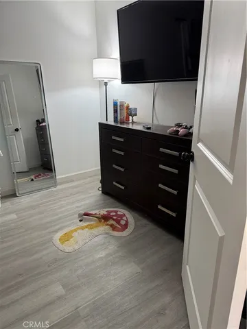 a view of a closet with wooden floor