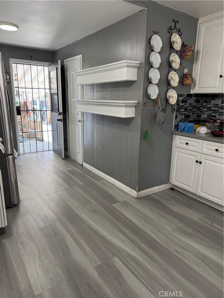 854 North 9th Street Colton, CA 92324 - Photo 7 of 36 a view of an empty room with a window and wooden floor