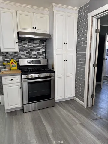 a kitchen with stainless steel appliances white cabinets and a stove