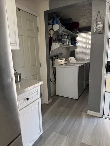 a view of washer and dryer with wooden floor