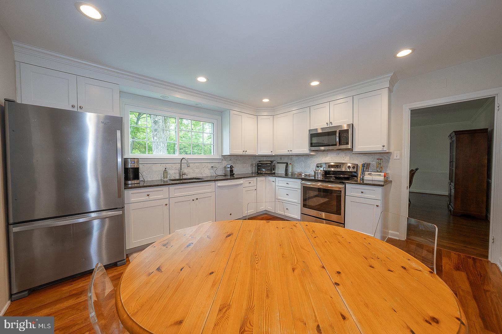 538 Conestoga Road Villanova, PA 19085 - Photo 12 of 39 a kitchen with kitchen island a refrigerator sink and wooden floor