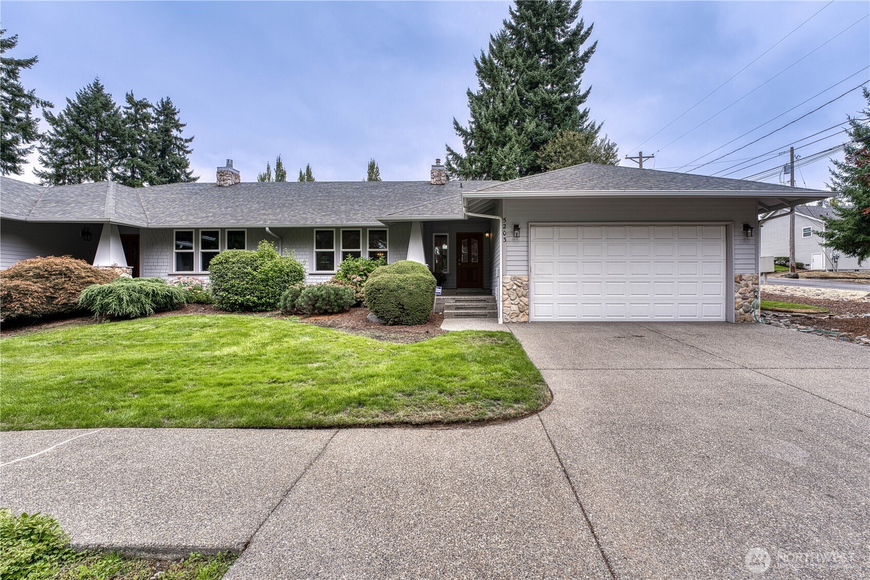 5203 53rd Street West University Place, WA 98467 - Photo 1 of 33 a front view of a house with a garden and plants