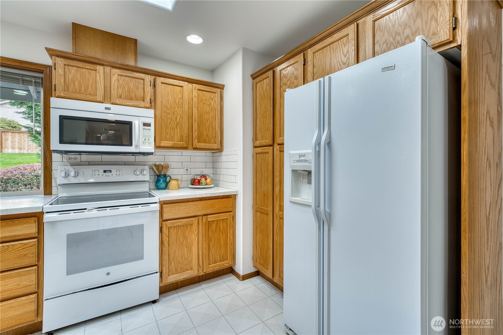 5203 53rd Street West University Place, WA 98467 - Photo 15 of 33 a kitchen with stainless steel appliances granite countertop a refrigerator and a stove top oven