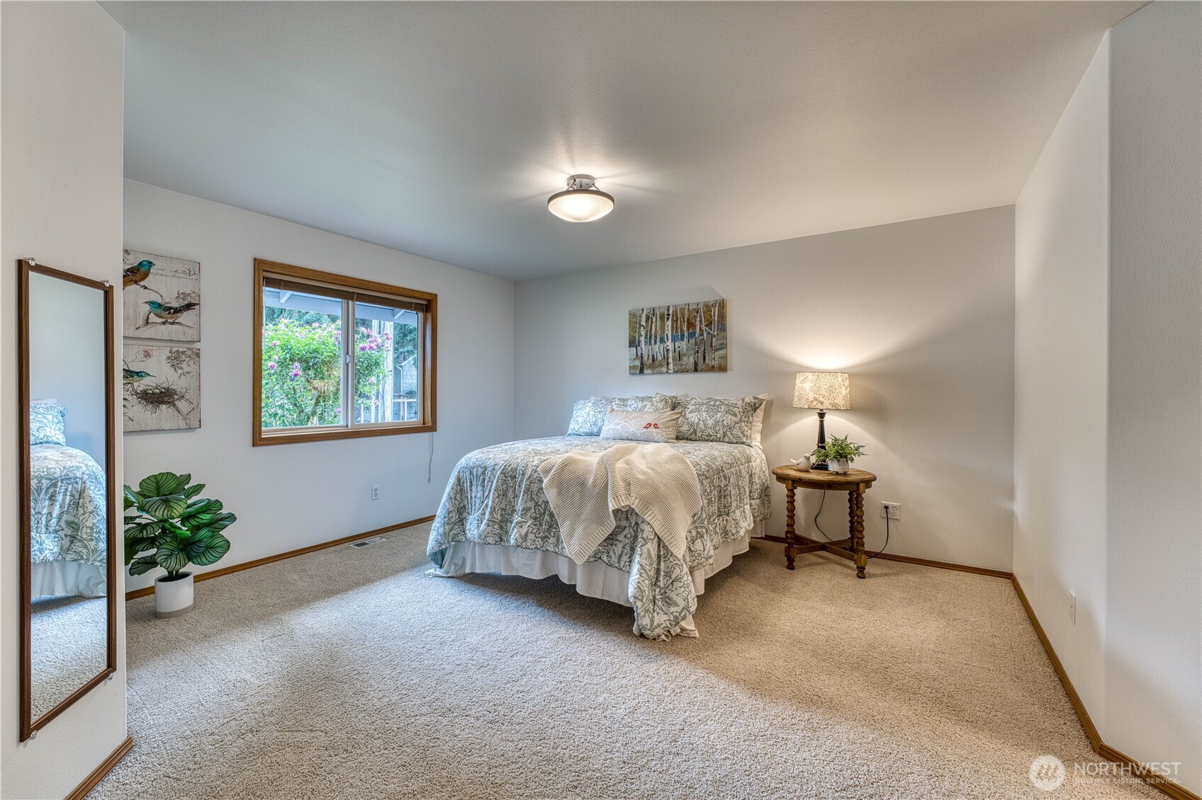 5203 53rd Street West University Place, WA 98467 - Photo 19 of 33 a bedroom with a bed and a potted plant