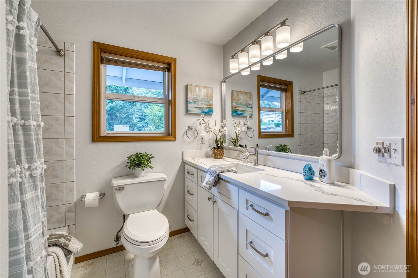 5203 53rd Street West University Place, WA 98467 - Photo 27 of 33 a bathroom with a toilet sink and mirror