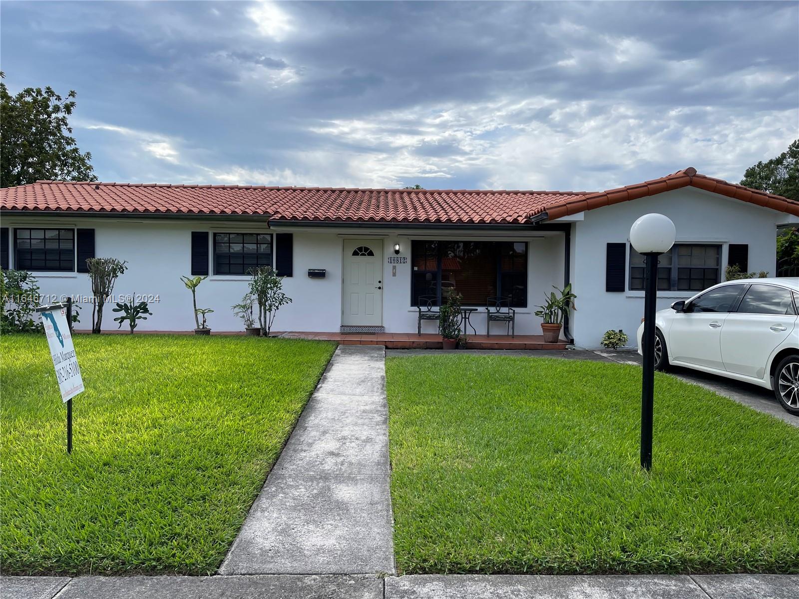 a front view of house with yard and seating
