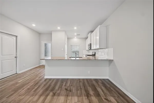 a view of kitchen with wooden floor