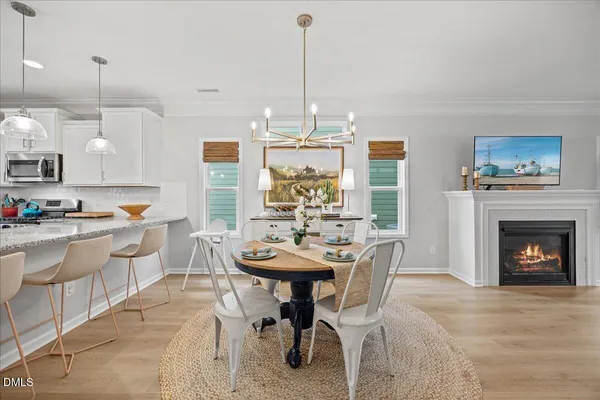 a living room with furniture a fireplace and kitchen view