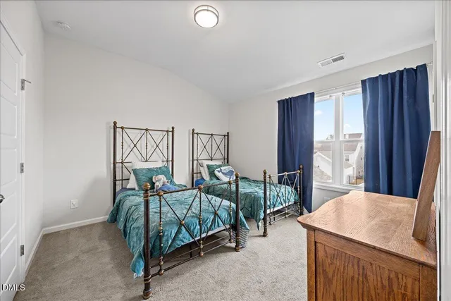 a bedroom with furniture and wooden floor