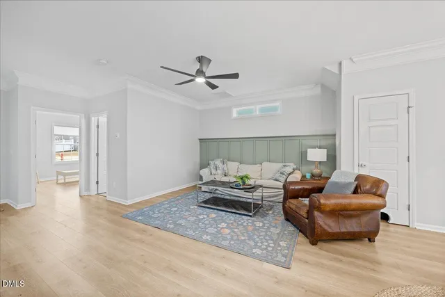 a kitchen with stainless steel appliances kitchen island granite countertop a table chairs refrigerator and microwave