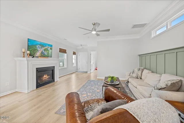 a kitchen with stainless steel appliances granite countertop a refrigerator a sink dishwasher a stove and white cabinets with wooden floor