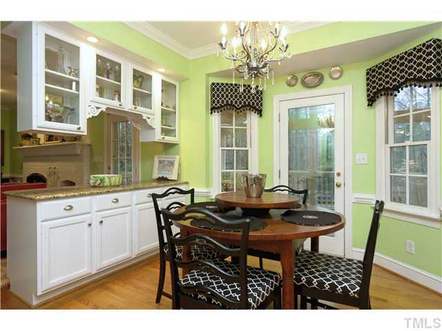 2104 Countrywood Road North Raleigh, NC 27615 - Photo 11 of 25 a view of a dining room with furniture and a chandelier
