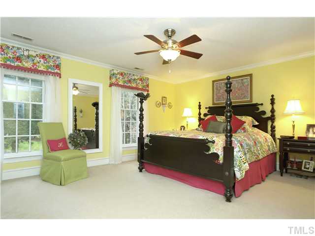 2104 Countrywood Road North Raleigh, NC 27615 - Photo 16 of 25 a bed room with a bed and a chair
