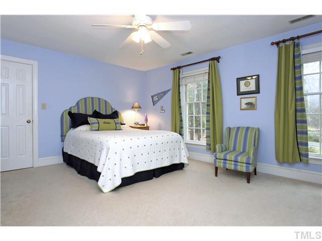 2104 Countrywood Road North Raleigh, NC 27615 - Photo 18 of 25 a bedroom with a bed chair and a window