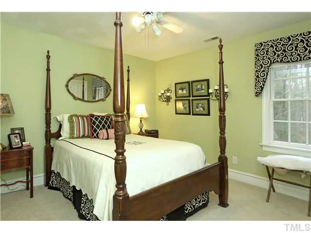 2104 Countrywood Road North Raleigh, NC 27615 - Photo 20 of 25 a bedroom with a bed and a table in it