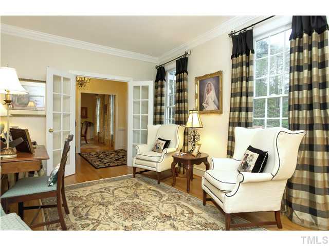 2104 Countrywood Road North Raleigh, NC 27615 - Photo 5 of 25 a living room with furniture and a floor to ceiling window