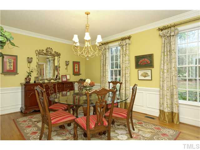 2104 Countrywood Road North Raleigh, NC 27615 - Photo 6 of 25 a view of a dining room with furniture and a chandelier