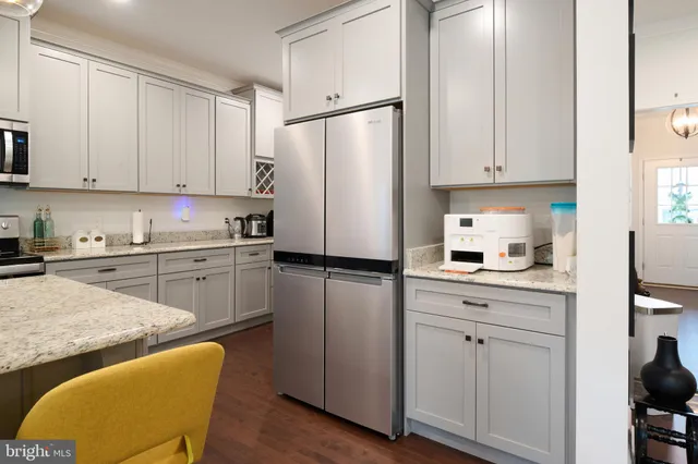 a kitchen with granite countertop a sink and cabinets