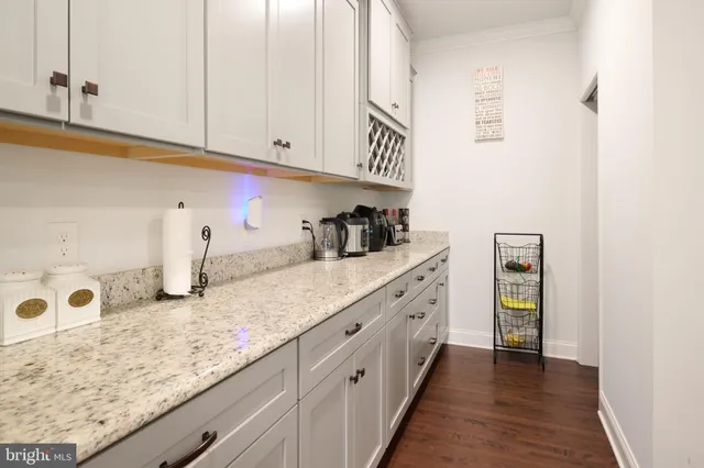 a kitchen with stainless steel appliances granite countertop a sink a stove and a wooden floors