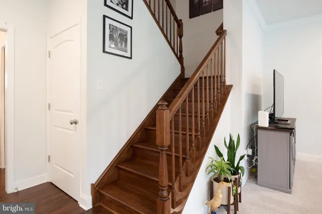 a kitchen with stainless steel appliances kitchen island granite countertop a refrigerator and a sink
