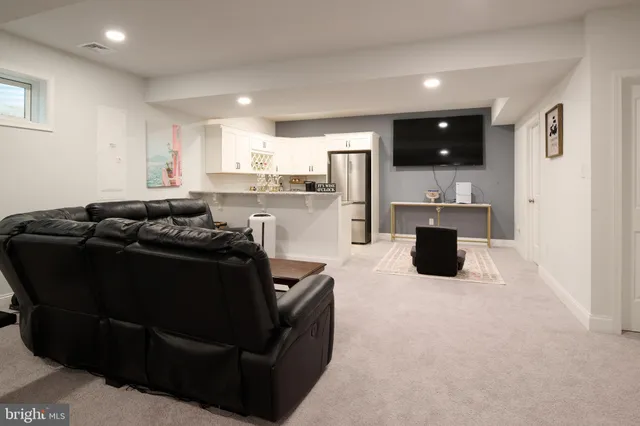 a kitchen with granite countertop a refrigerator and a sink