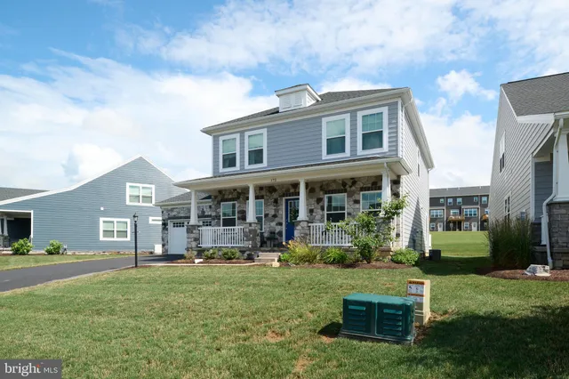 a front view of a house with a garden and plants