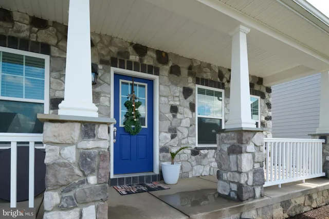 a room with wooden floor a mirror a clock and a window