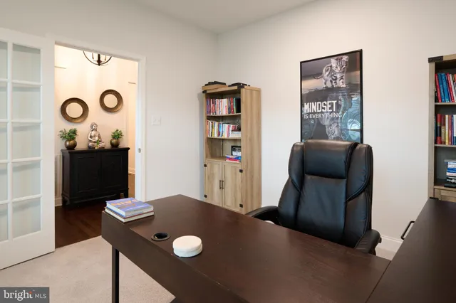 a view of a hallway with wooden floor and a cabinet