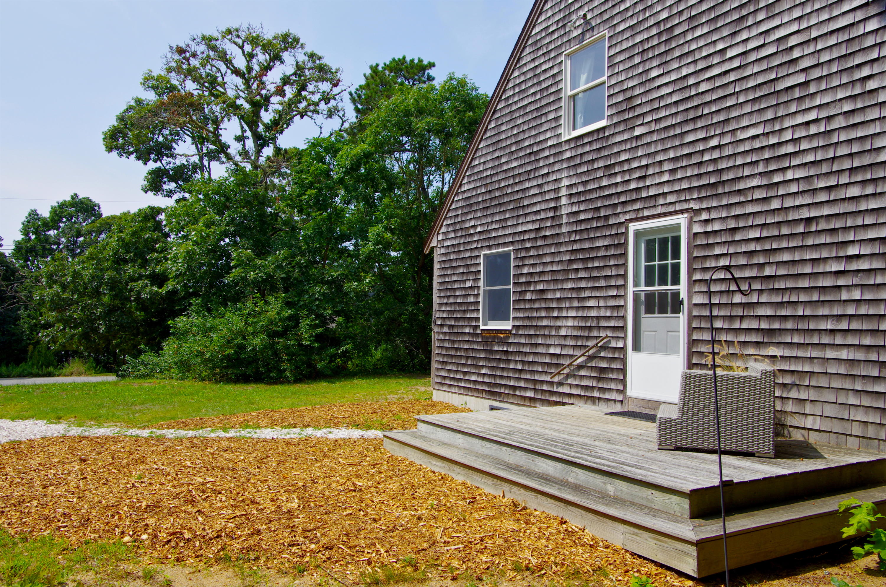 10 Juniper Way Eastham, MA 02642 - Photo 4 of 31 a view of a backyard with a garden