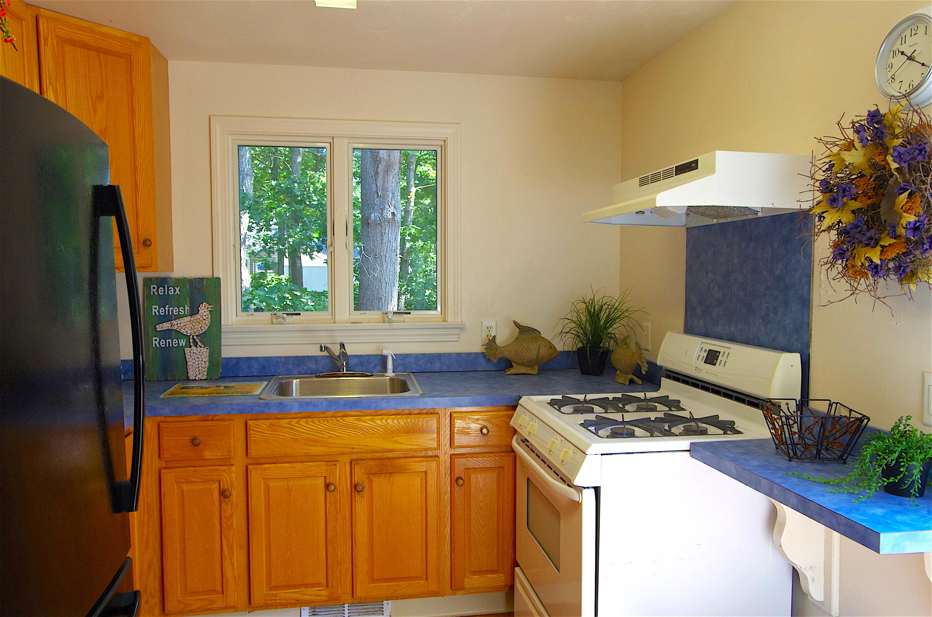 10 Juniper Way Eastham, MA 02642 - Photo 6 of 31 a kitchen with stainless steel appliances granite countertop a sink stove and refrigerator