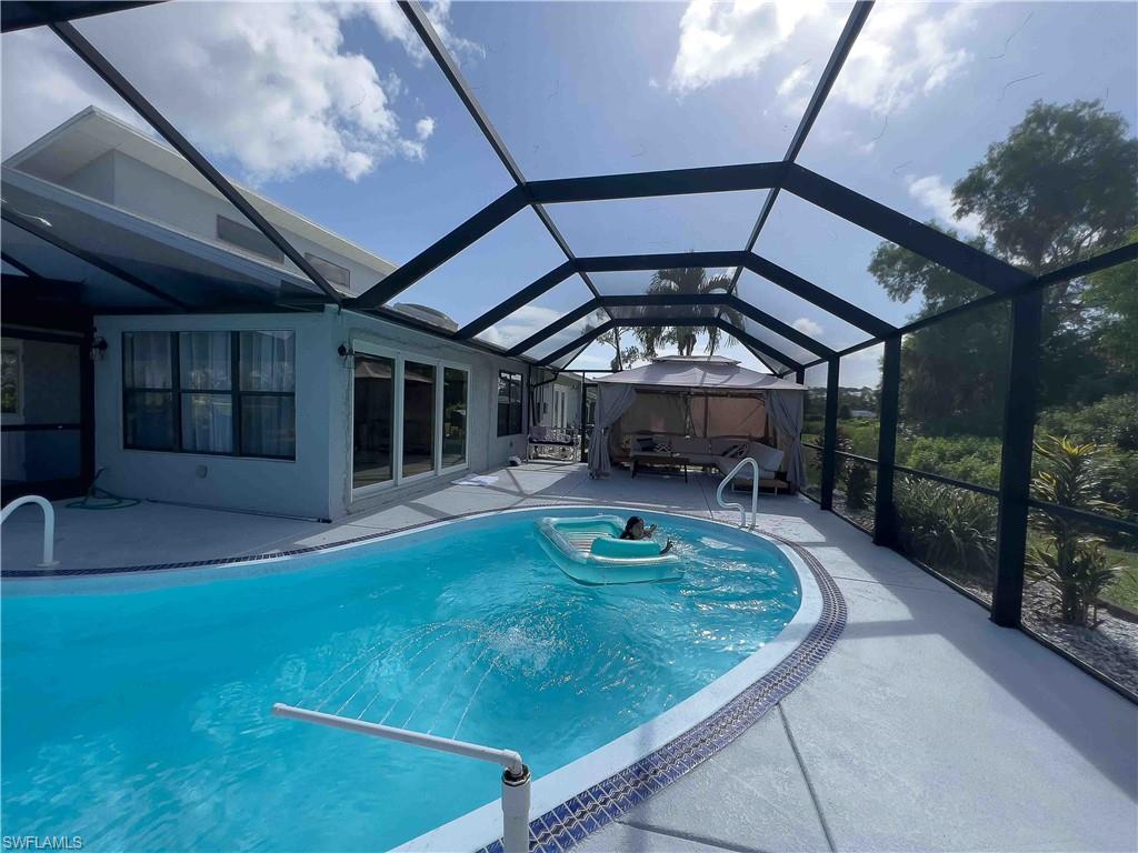 3220 63rd Street Southwest Naples, FL 34105 - Photo 16 of 36 Outdoor pool featuring a patio and a lanai