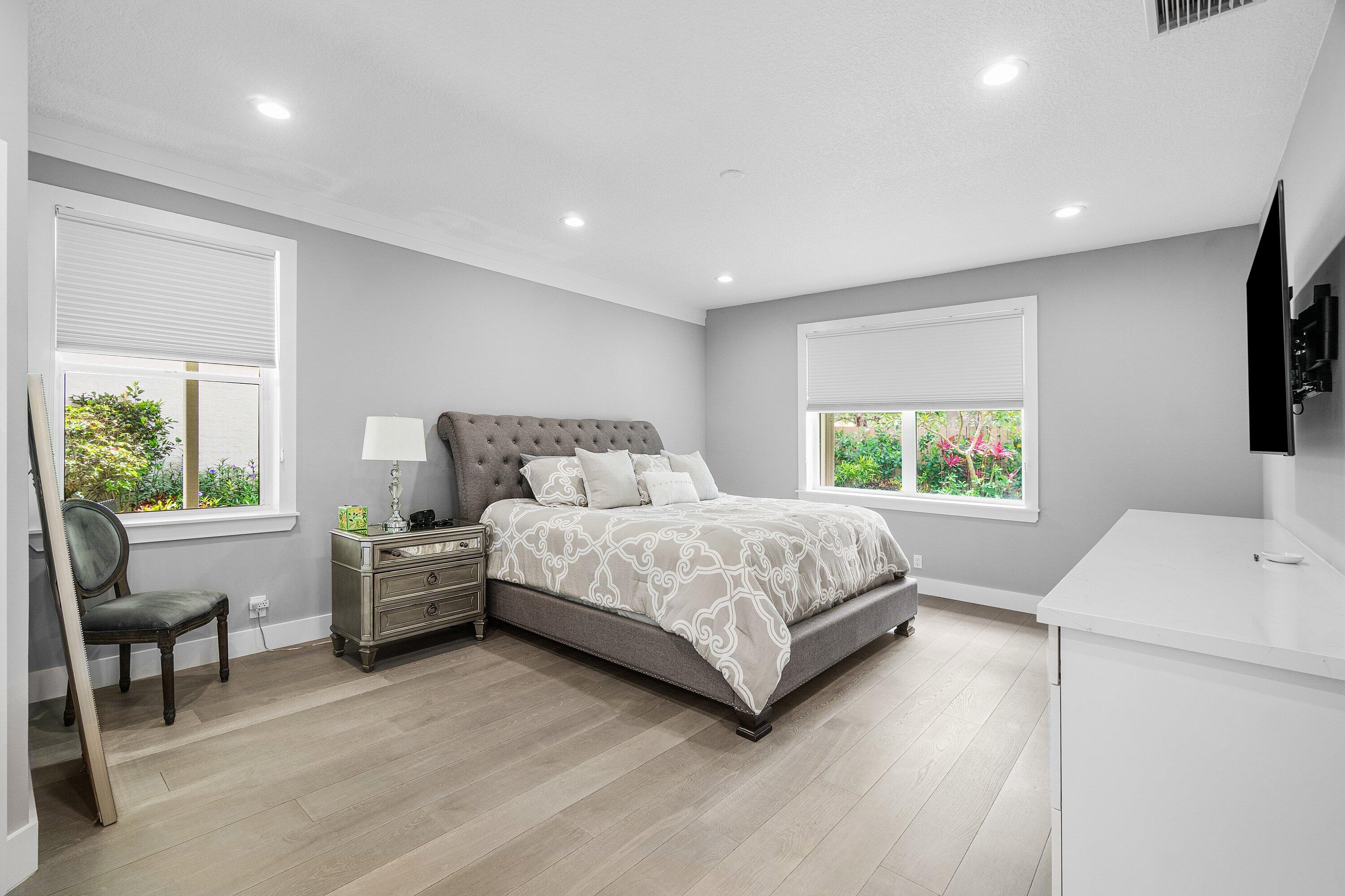 2404 Northwest 67th Street Boca Raton, FL 33496 - Photo 19 of 74 a bedroom with a bed and a table
