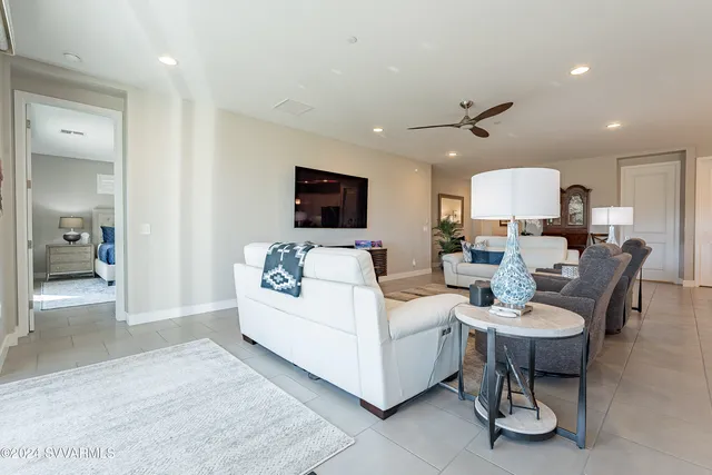 a kitchen with stainless steel appliances kitchen island granite countertop a dining table chairs and white cabinets