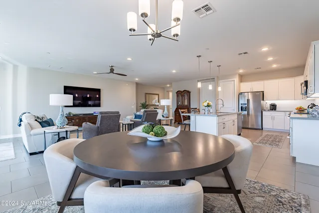 a spacious bathroom with a granite countertop sink a mirror and shower