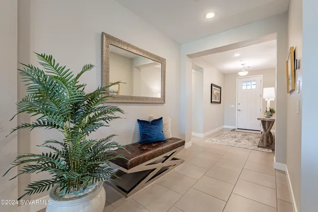 a bathroom with a granite countertop sink toilet a large mirror a shower and a bathtub