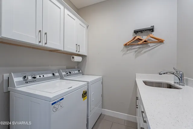 a view of a patio with table and chairs potted plants with floor to ceiling window and potted plants