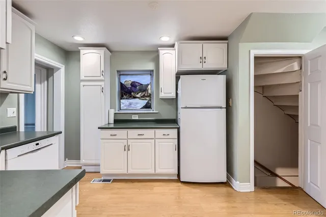 a refrigerator freezer sitting inside of a kitchen