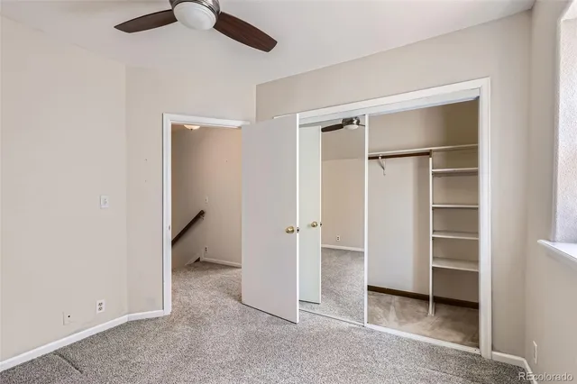 a view of a hallway with wooden floor and entryway