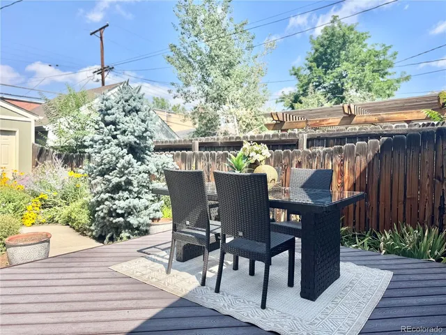 a view of outdoor dining space with a table and chairs