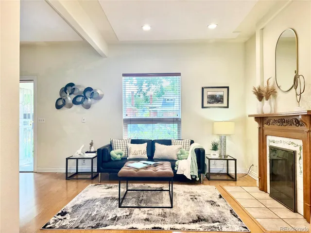 a living room with furniture a fireplace and a table
