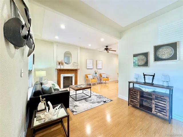 a living room with furniture a fireplace and a flat screen tv