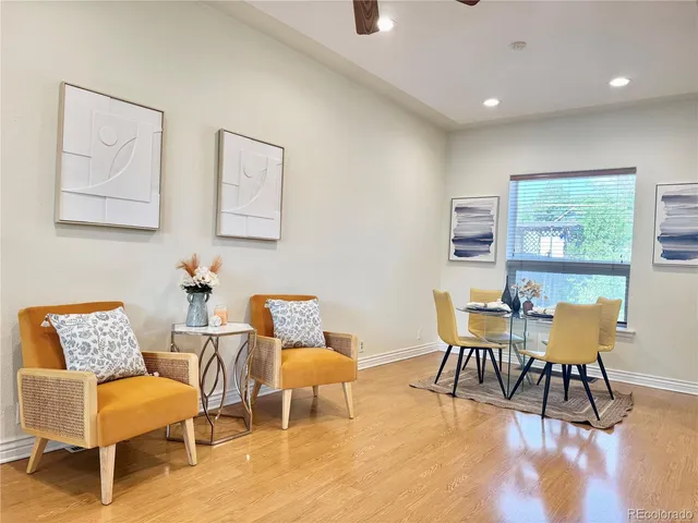 a view of a dining room with furniture a rug and wooden floor