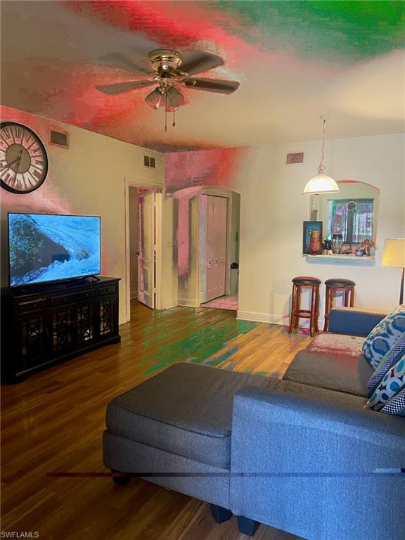 4110 Castilla Circle, Unit 101 Fort Myers, FL 33916 - Photo 4 of 5 a bedroom with a bed and a flat screen tv