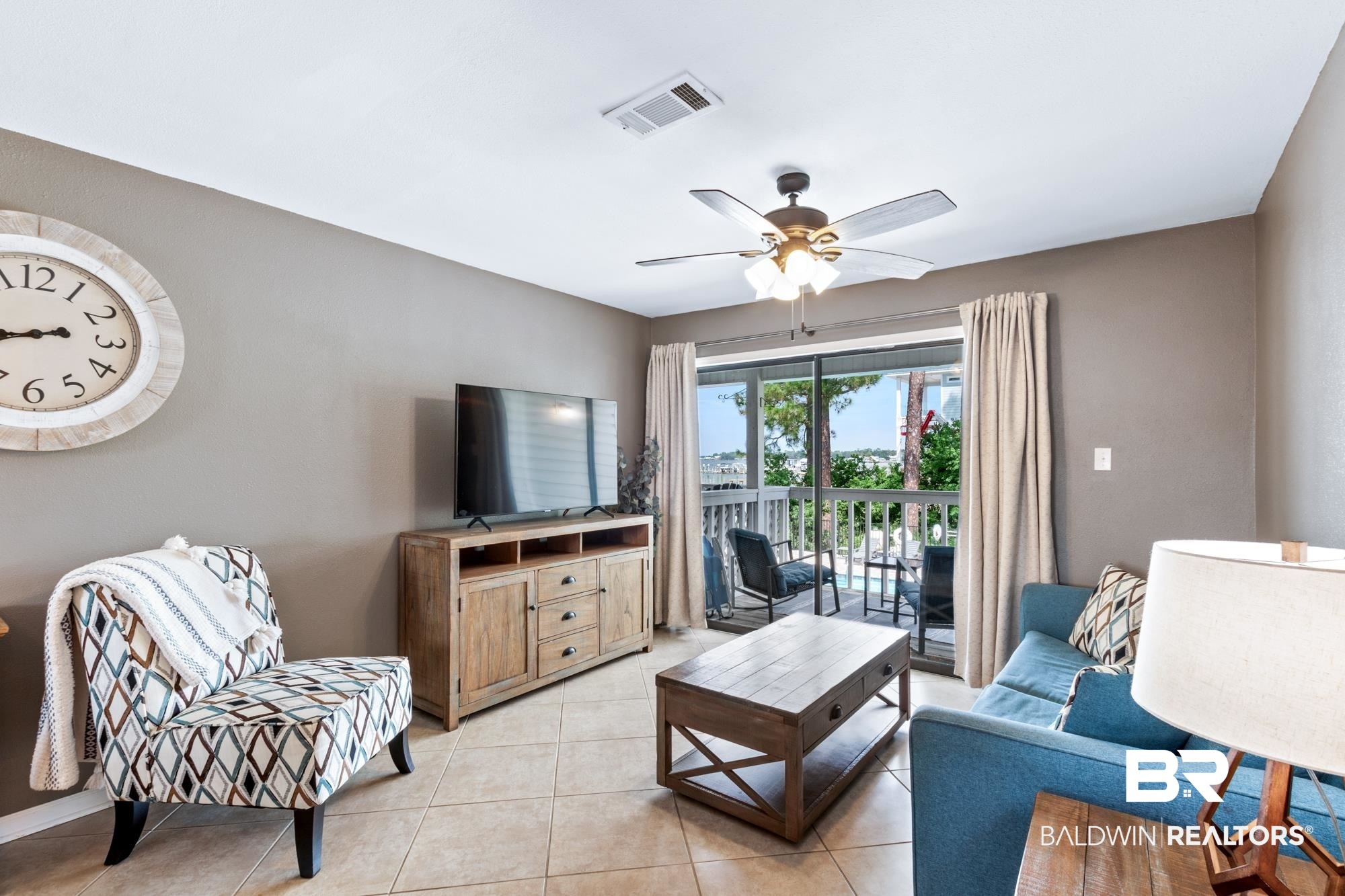 25925 -C Canal Road, Unit 203 Orange Beach, AL 36561 - Photo 17 of 57 Living room featuring ceiling fan and light tile patterned floors